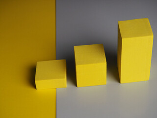 pedestal squares shadows on a yellow and gray background