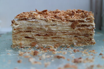 Cake Napoleonpiece of layer cake with crumbs close up