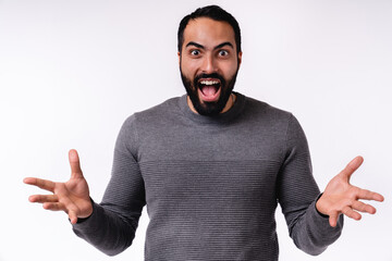 Close up photo of overexcited young Arab man in casual clothes isolated over white background