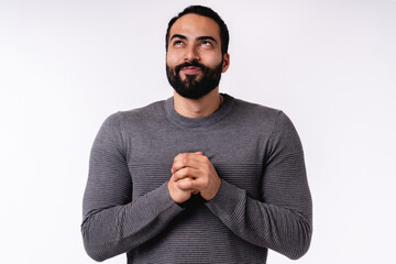 Attractive young Arabian man making a wish in casual clothes isolated over white background