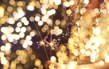 happy New Year sparklers on golden bokeh background