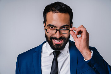 Cropped young Arabian businessman in formal attire and glasses isolated over grey background
