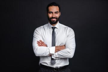 Portrait of arab businessman with arms crossed isolated over black background