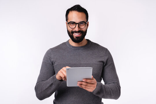 Middle East Man In Casual Clothes Using Tablet Isolated Over White Background