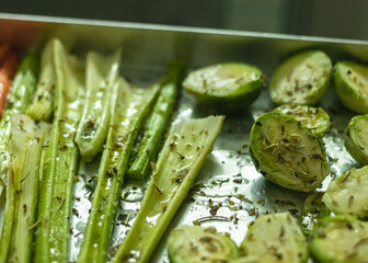asparagus and brussel sprouts on a baking tray