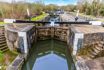 A view of the first lock at Hatton Locks, UK with the lock staircase in the distance on a winters day