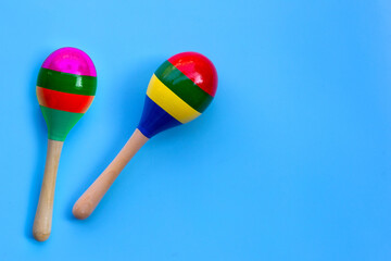 Two maracas on blue background.