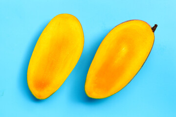 Mango on blue background. Tropical sweet fruit concept.