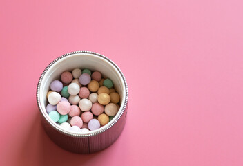 Obraz na płótnie Canvas Set of decorative cosmetics on pink background. Powder in balls 