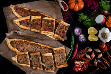 Traditional Turkish food, lahmacun and kiymali and kusbasili pide. Many kinds of traditional food on the rustic table. 