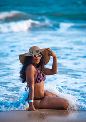 A woman in bikinis enjoying herself in the beach 