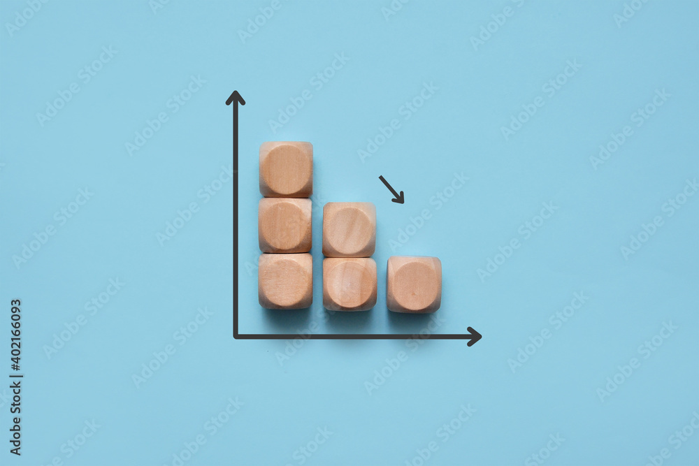 Poster wooden cubes in the form of a growing down graph. symbolic image of the graph of declining profits, 