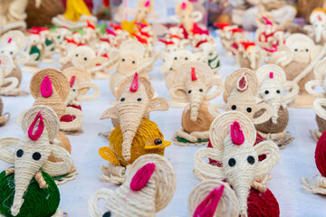 Fototapeta na wymiar Lord Ganesha dolls made from jute, Handicrafts for sale at Kolkata handicrafts fair, West Bengal, India.