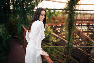 Young woman relaxes in orangery.