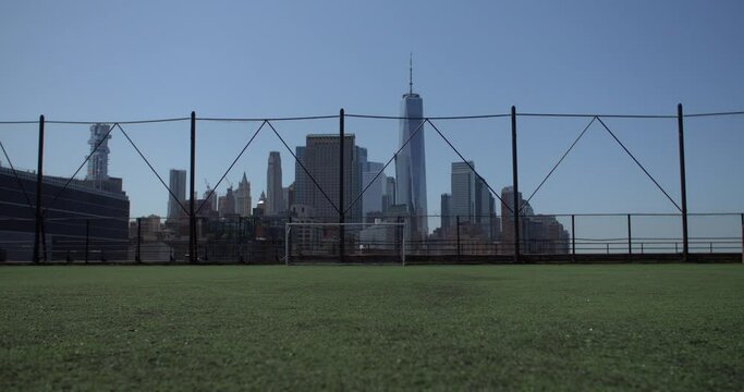 a impressive soccer field with a gate, new york skyline in the background