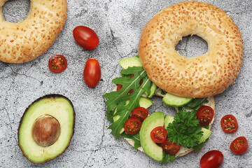 Sesame bagels with tomatoes and avocado