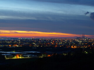 Fototapeta na wymiar sunset over the town and coal-burning power plant