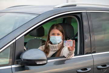 woman holds driving license