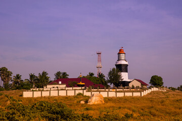 Fototapeta na wymiar A view of a lighthouse standing at the coast of Muttom beach, Tamil Nadu, India