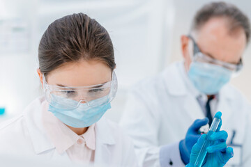 close up. female scientist with a test tube in her hands.