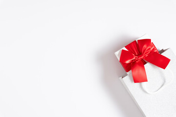 Gift box with red bow on white background. Valentine day, birthday, Christmas, concept, design. Flat lay, top view, copy space