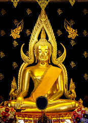 Fototapeta premium Closeup Shot of The Beautiful Phra Buddha Chinnarat (Sukhothai-style), One of The Most Important or Famous Buddha Statues in Thailand. Selective Focus at The Buddha Face and Blurred Background.