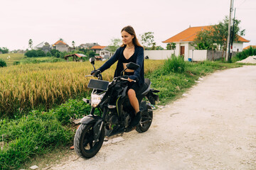 Fototapeta na wymiar Young woman riding bike and looking at road