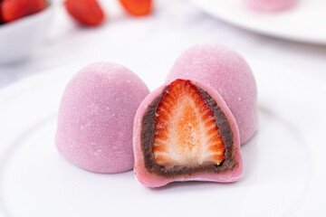 Japanese confectionery Ichigo Daifuku, small round glutinous rice dessert with fresh strawberry and red bean paste