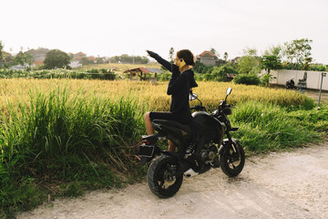 Fototapeta na wymiar Faceless woman having phone conversation on motorbike