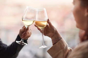 Close-up of young happy couple drinking champagne during romantic date in the restaurant