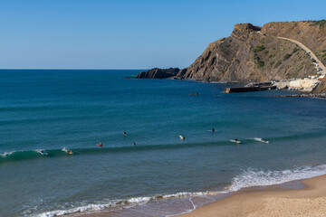 many surfers enjoy a surf session in the waves at Arrifana