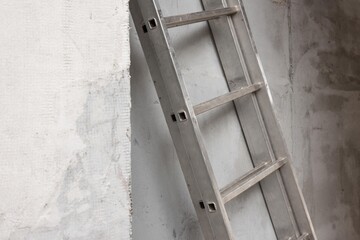 metal ladders isolated on concrete wall