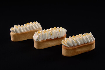 Fototapeta na wymiar Three cookies with whipped mascarpone cream topping.