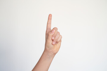 isolated child hand shows the number one. young hand gesture sign. raising hand. ask to speak. pointing finger. 