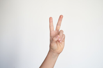 isolated child hand shows the number two. young hand gesture sign. peace victory symbol. 