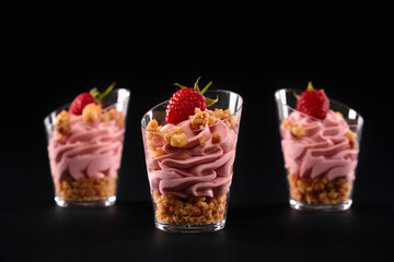 Isolated closeup of raspberry creamy layered parfait.