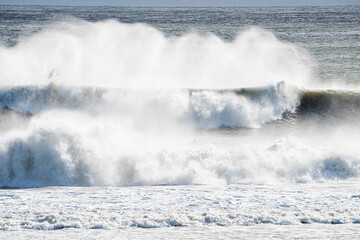 Fototapeta premium Ocean waves with large, white sprays on the Atlantic Ocean during a storm.