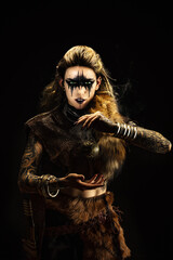 Portrait of a young viking shaman holding a ball of incense in his hands
