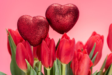 St Valentines day composition with bouquet of tullips and two red hearts