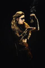 Portrait of a young viking shaman holding a ball of incense in his hands