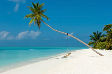 Tropical beach paradise as summer landscape with beach swing  or hammock and white sand. Luxury beach scene vacation summer holiday. Exotic island nature travel destination