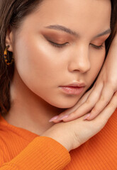 Portrait of a attractive girl with healthy clean skin and fresh make-up. Aesthetic cosmetology and makeup concept.