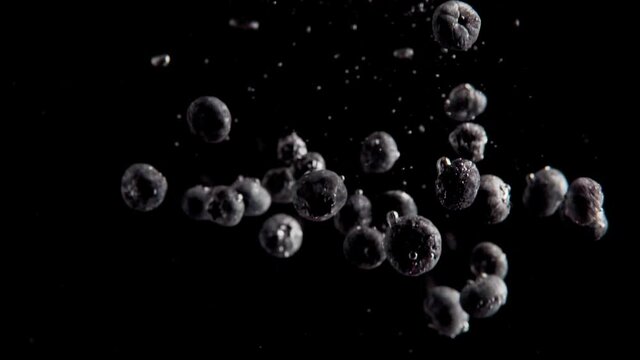Currants Falling into Water Super Slowmotion, Black Background, lots of Air Bubbles, 4k240fps