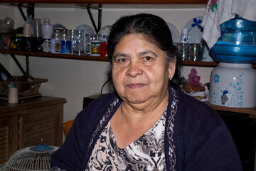 Female chef posing with plates of traditional food- enchiladas de mole