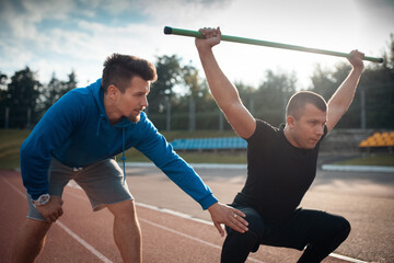 sport man has workout or exercising outdoor with personal fitness trainer