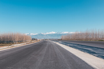 Highway under construction with Sierra Nevada in the background