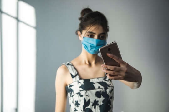 woman in mask make selfie
