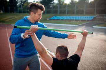 sport man has workout or exercising outdoor with personal fitness trainer