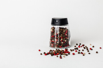 Salt and pepper grinders. Dried whole seed of black pepper and white coarse sea salt isolated on a...