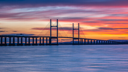 Severn Bridge crossing from England to Wales, at sunset.  The bridge is also called the Price of...